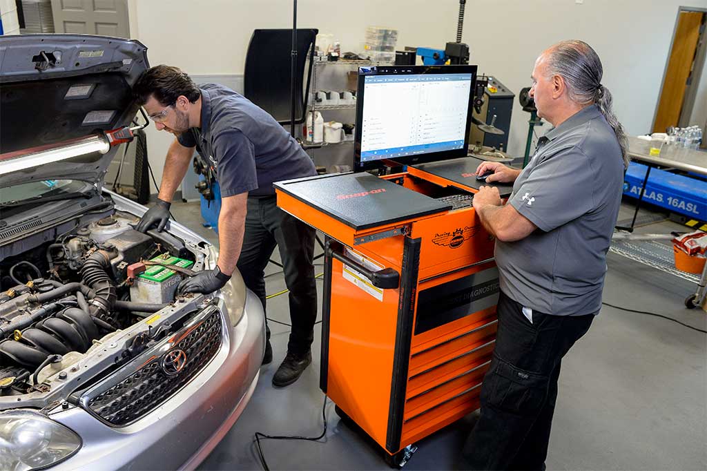 Technician-Training_Brand-Photo-1 Technicians diagnosing a vehicle